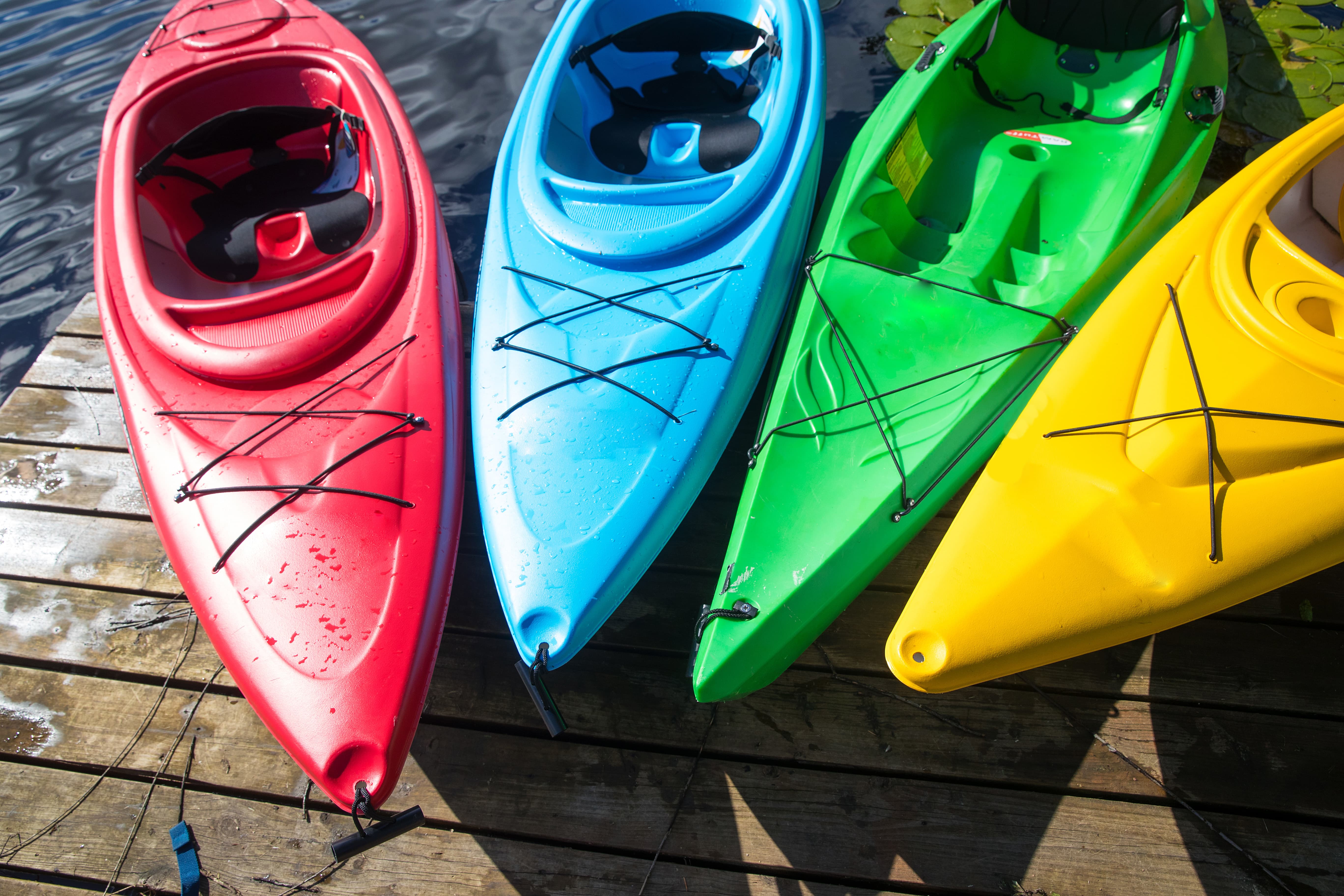 Group of Colorful Kayaks on Dock