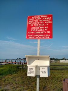 sign at the Chincoteague boat ramp, explaining the ramp fees and how to pay