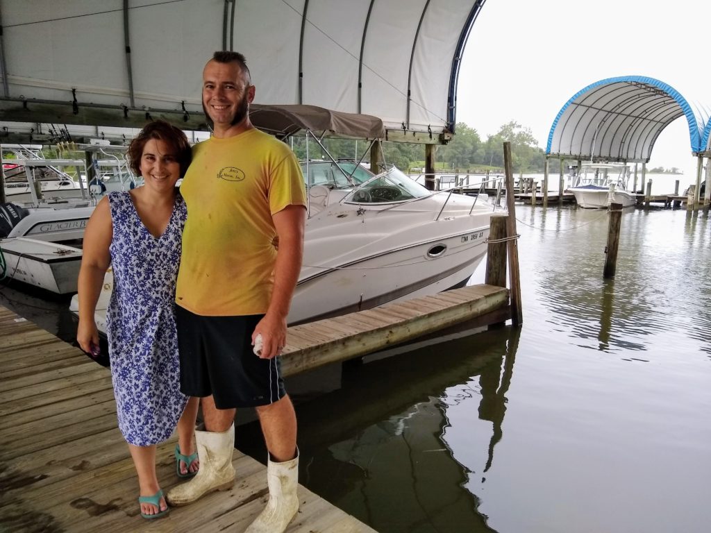 Rogue Oysters owners standing on a dock at the marina
