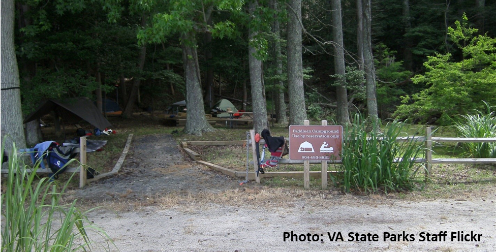 small campground with gravel walkway in foreground and tents in the background